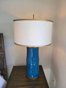 A Pair of Blue Table Lamps with Gold Trimmed Shades.