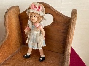 lot 13 image: Wicker Doll Buggy, Porcelian Doll, and Wooden Chair