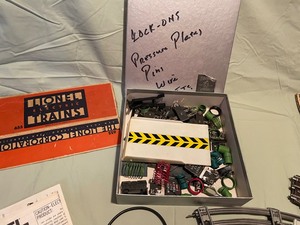 lot 11 image: Lionel Collection of pressure plate, track, manuals, switch and box