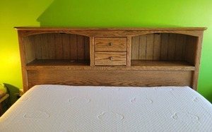 Queen oak bedframe with adjustable mattress base.