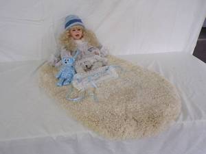 lot 125 image: Baby Doll with Teddy Bear and Rug