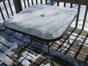 Metal framed Glass top patio table with umbrella holding capability