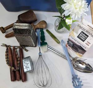 lot 84 image: Farberware Deluxe Rotary Grater-Four Kitchen Cooking Utensils-Three Candles-Vase With White Flowers In It--Etc.