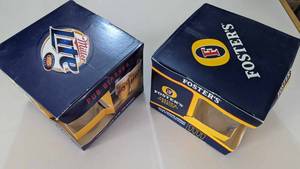 lot 114 image: Four 16 OZ. Miller Lite Pub Glasses In Case-Four 16 OZ. Fosters Pub Glasses In Case