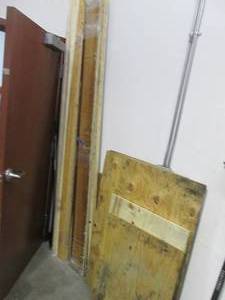 lot 36 image: Corner with plywood, 1x4, 2x4 and other assorted wood sections