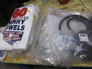 lot 43 image: Stack of Terry cloth hand towels plus air tubing a d vehicle wire protectant