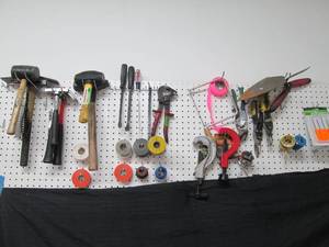 lot 90 image: Wall lot consisting of Assorted hammers, pry tools, snips, pipe cutters, hookpick set, saws, electrical tape and more
