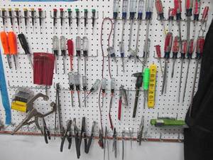 lot 91 image: Huge wall lot consisting of a large assortment of screwdrivers, pliers, nut drivers and other tools
