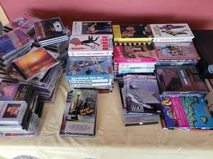 lot 48 image: A large group of DVDs, CDs, VHS and Cassettes. Approximately 150 in total. Great Variety.