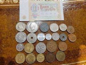 lot 56 image: A group of foreign coins and a single note.
