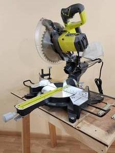 lot 11 image: Ryobi 10 Sliding Compound Miter Saw Mounted on a Stand