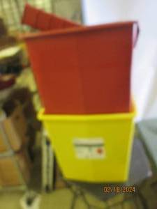 lot of red and yellow garbage cans with more smaller storage items