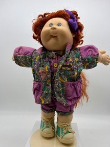 lot 52 image: Vintage CABBAGE PATCH Growing Hair Doll Redhead Cornsilk Dressed in A Designer Line Outfit
