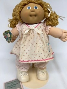lot 75 image: Vintage Cabbage Patch Double Braid Blue eyed Girl in Sailboat Floral Dress CARLA SUZETTE Papers & Hang tag