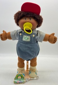 lot 24 image: 25th Anniversary CABBAGE PATCH Brown Fuzzy Boy w Paci and Red Hat Original Hang Tag Play Along