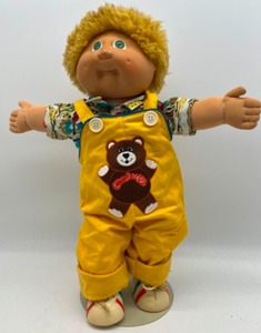 lot 22 image: Vintage CABBAGE PATCH Fuzzy Blonde Head Boy with Green eyes in Teddy Bear Overalls