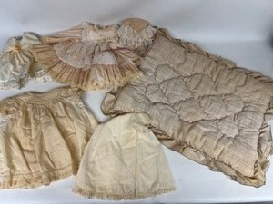 lot 257 image: Vintage Antiqued White DOLL Items Slips and Dresses, & Baby Quilt