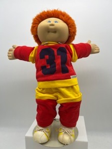lot 13 image: Vintage CABBAGE PATCH Orange Fuzzy Boy in Red Fleece Jogger Suit