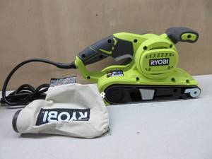 lot 208 image: Ryobi BE319 6 Amp Portable 320 Feet  Minute Corded Belt Sander (3 x 18) w Onboard Removable Dust Bag (Medium Grit Sanding Belt Included)- NEW, TESTED, WORKS