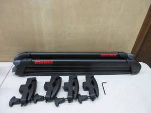 lot 241 image: Yakima, PowderHound 6 Ski & Snowboard Mount, Fits Up to 6 Pairs of Skis or 4 Snowboards, Rides Quietly, Fits Most Roof Racks, Black.   MISSING SKS KEY, ONE RACK IS LOCKED, USED