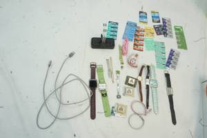 Variety of Watch Batteries, used Watches, game charging station