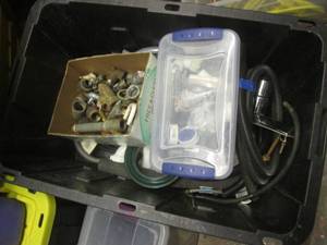 Large covered tote containing a variety of plumbing parts and accessories