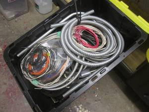 Covered tote containing electrical wite, conduit and other supplies