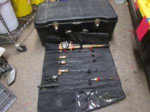Large Plastic storage trunk containing a variety of ice fishing rods