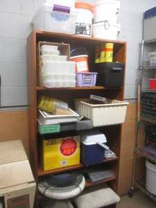 Bookshelf and all content including a variety of fishing coolers, live wells and other supplies (buyer must take all)