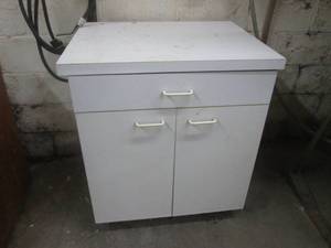 White coated wood cabinet measuring approximately 322536