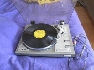 Vintage Akai direct drive auto return Model AP-206 Covered turn-table record player with a currently loaded Johnny Cash vinyl record album
