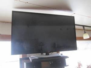 42 LG flat-screen TV with base and wall mount. (bring proper tools to remove)