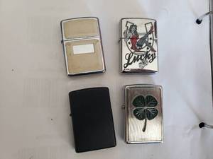 lot 23 image: 4 Zippos - Lucky 7, Four Leaf Clover and 2 Others