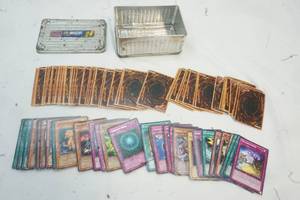lot 153 image: Nasar Tin with a Variety of Yu-Gi-Oh trading cards
