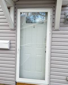lot 7 image: Exterior Entry Door and Storm Door