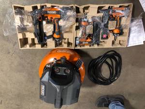 lot 19 image: RIDGID 6 Gal. Portable Electric Pancake Air Compressor w 18GA Brad Nailer, 16GA Straight Finish Nailer, & 18GA Finish Stapler    Customer Returns See Pictures