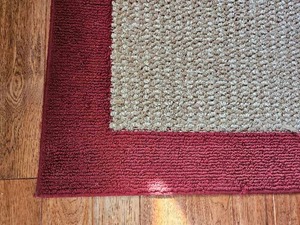 lot 136 image: Cranberry Trimmed Wheat Area Rug  5 x 7