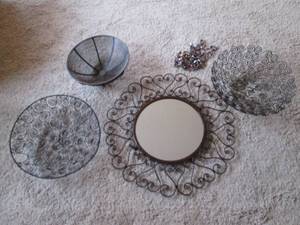 lot 12 image: Decorative mirror encased with scrolling metal accents accompanied by decorative open metal baskets