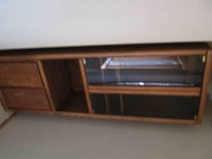 lot 21 image: Wood multimedia cabinet with glass doors on top and solid doors neat the bottom separated by an open tier for display