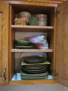 lot 27 image: Green and tan toned stoneware plates, bowls and serving pieces