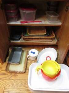 lot 30 image: Cupboard content consisting of Food storage, assorted serving trays, mixing bowls and casserole dish