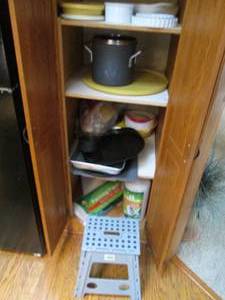 lot 31 image: Content of Pantry to include a variety of bakeware, covered stock pot with home helpers and other supplies