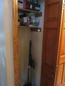 lot 36 image: Hallway Closet content to include a variety of sliding furniture robots, replacement light bulbs, swiffer cleaning pads, broom, dusters and more