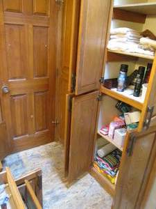lot 39 image: Content of cupboards in main bathroom to include a variety of towels and bedding, cosmetics, first aid supplies, and a large assortment of personal care supplies and accessories