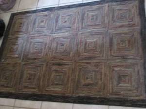 lot 61 image: 46 Deep neutral tones in a swirled tile design offered area rug