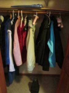 lot 65 image: Content of Lower Level Bedroom closet containing a fantastic variety of Name Brand Womens size LXL Casual and Classy Winter coats with a few other pieces of outerwear including a 3-in-1, a plush bathrobe and a large soft wrap blanket
