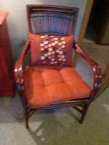 lot 66 image: Distinguishing detailed Twisted Wicker or Bamboo styled arm chair with padded seat cushion and accent pillow