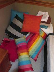lot 71 image: Mountain of vibrant accent pillows, quilts and bed linens, pillows and bath towels