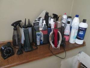lot 85 image: Sterling Eclipse and Ruby Beauticians clippers along with a large assortment of hair care and other beauty type supplies