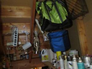 lot 97 image: Large lot containing a variety of solid color wood stains, sparkling, putty, decreased, duct tape, spray paints, insulated coolers, paper towels, toilet paper and other supplies